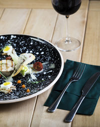 High angle view of food in black plate on table