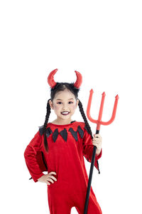 Portrait of smiling girl standing against white background