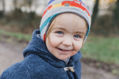 Portrait of cute girl smiling outdoors