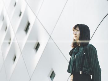 Low angle view of woman standing against sky