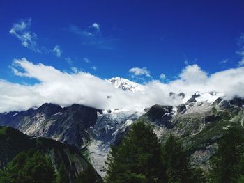 Scenic view of mountains against blue sky