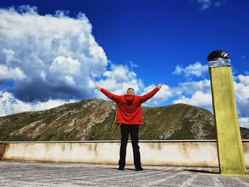 Rear view of man standing against sky