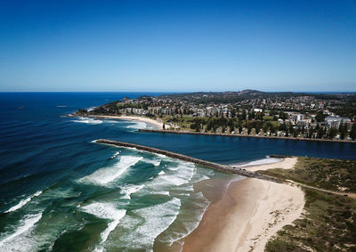 High angle view of sea against clear blue sky