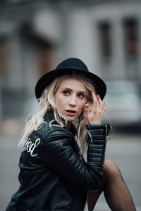 Portrait of beautiful young woman wearing hat