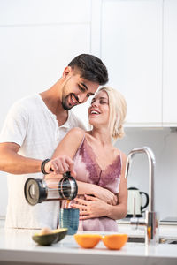 Young couple kissing at home