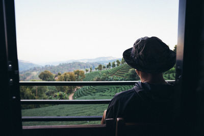 Asian male tourists admire the beauty of tea plantations, chiang rai, thailand.