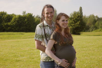 Portrait of a smiling young couple expecting baby