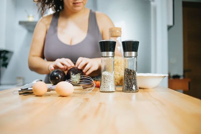 Midsection of woman preparing meal at home