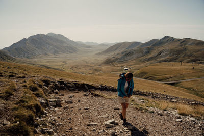 Rear view of man walking on mountain