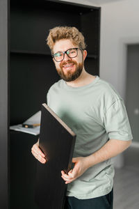 Portrait of young man using digital tablet at home