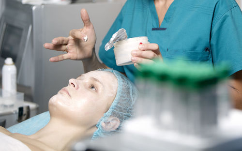 Close-up of woman getting beauty treatment from doctor