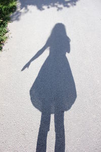 Shadow of woman on road