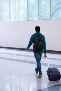 Rear view of man working at airport