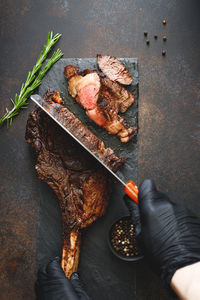 High angle view of hand holding food on table