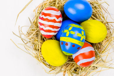 Close-up of multi colored eggs in basket