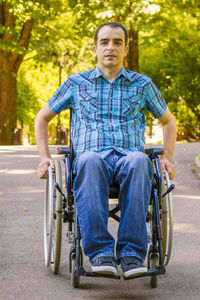 Portrait of physically disabled man sitting on wheelchair