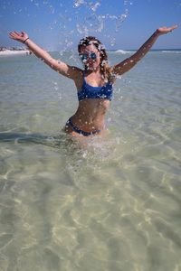 Full length of boy enjoying in sea