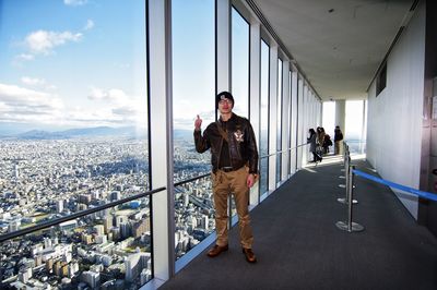 Men standing on railing against buildings in city