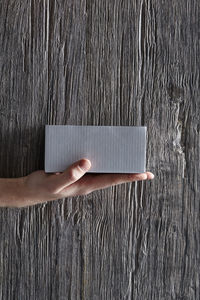 Directly above shot of person hand on wooden wall