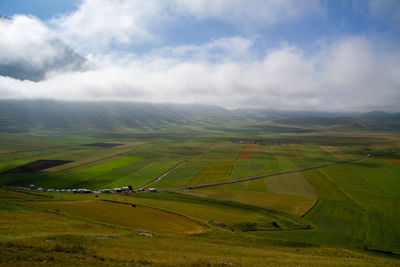 Scenic view of agricultural field against sky