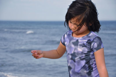 Full length of girl standing on sea shore