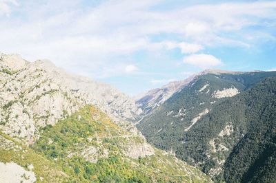 Scenic view of mountains against cloudy sky