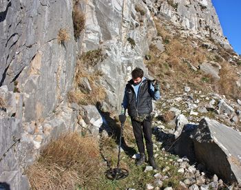 Full length of young man standing on rock