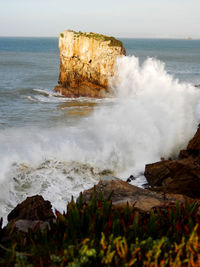 Scenic view of rocks on sea shore