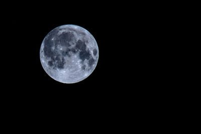 Low angle view of moon against sky at night