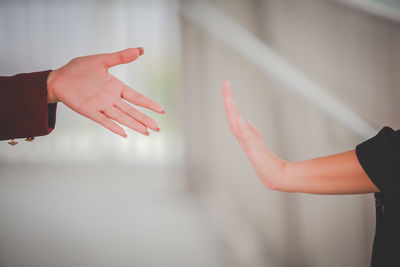 Midsection of woman with arms raised