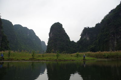 Scenic view of lake and mountains against sky