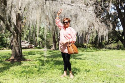 Full length of a woman standing on grassland