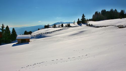 Scenic view of snow covered mountains against clear sky