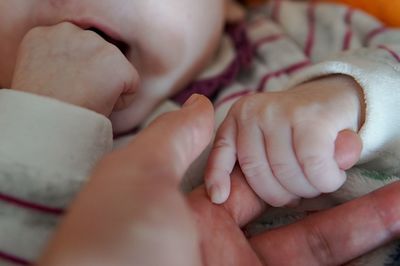 Close-up of baby holding hands