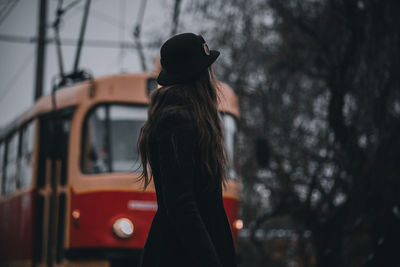 Rear view of woman standing in bus