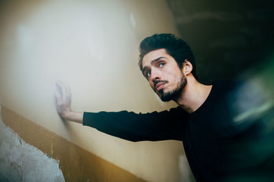 Young man by wall