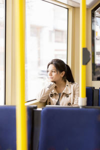 Woman in tram looking through window