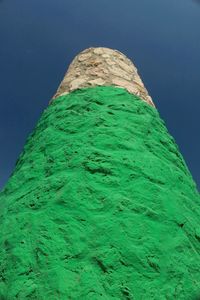 Low angle view of leaf against blue sky