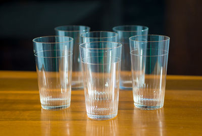 Close-up of glasses arranged on table