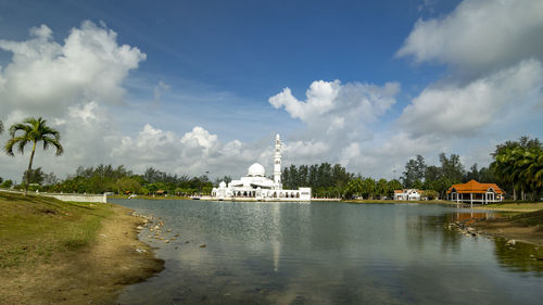 Panoramic view of building and trees against sky