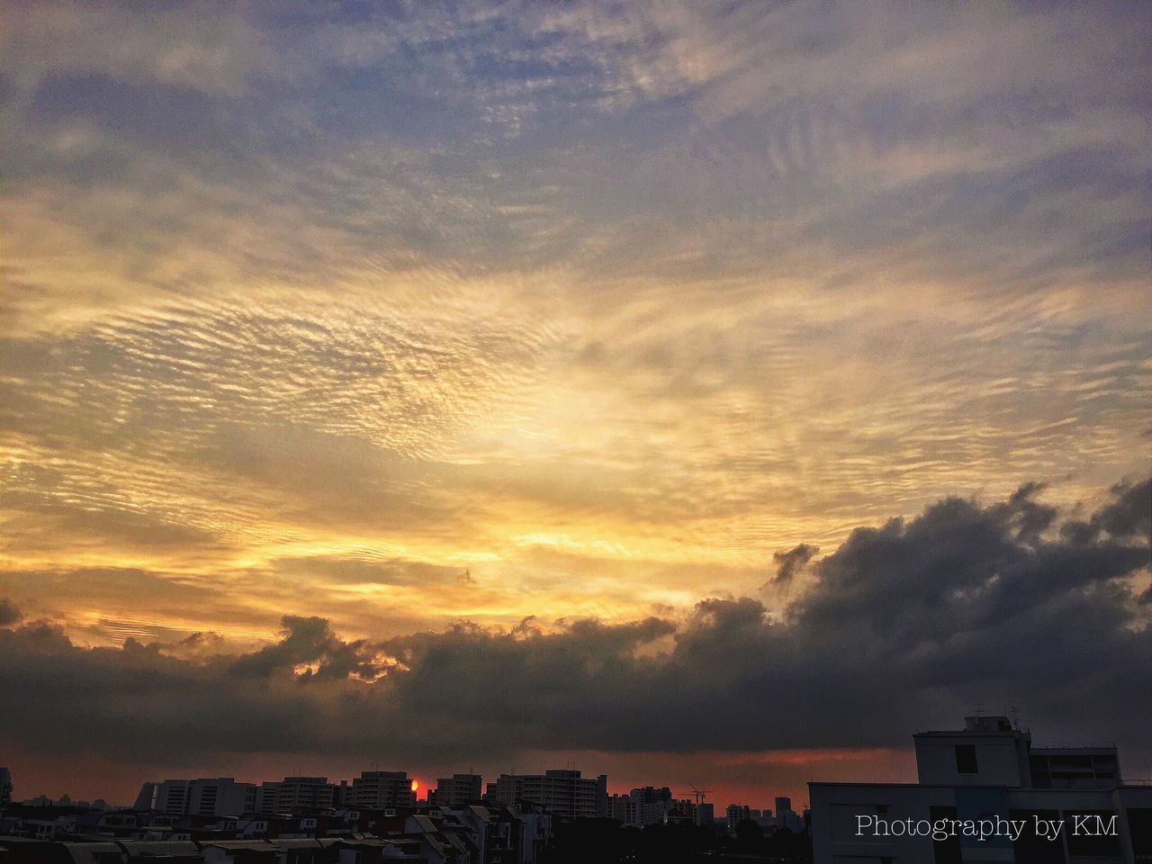 building exterior, architecture, built structure, sky, sunset, city, cloud - sky, cityscape, silhouette, residential building, dusk, cloudy, residential structure, dramatic sky, residential district, cloud, weather, building, orange color, scenics