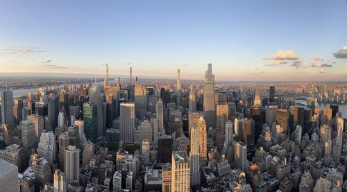 Aerial view of cityscape against sky during sunset