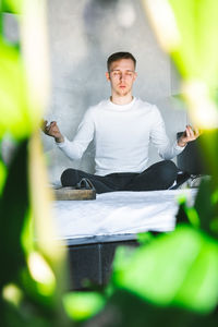 Young man sitting at home