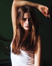 Portrait of young woman standing at home