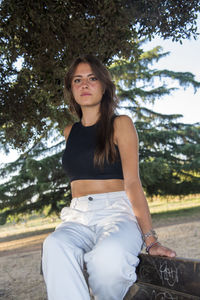 Beautiful italian girl at the park, wearing a dress