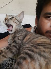 Portrait of young man with cat