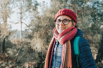 Portrait of young woman standing in forest