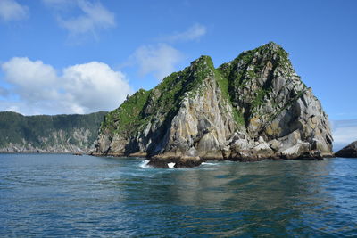 Scenic view of sea and mountains against sky