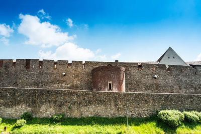 Low angle view of historical building in city against sky