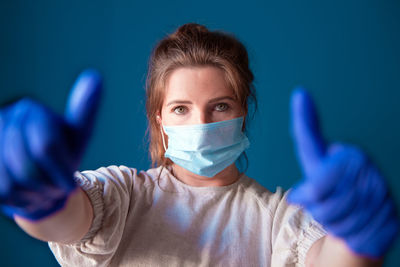 Portrait of woman wearing mask and gloves